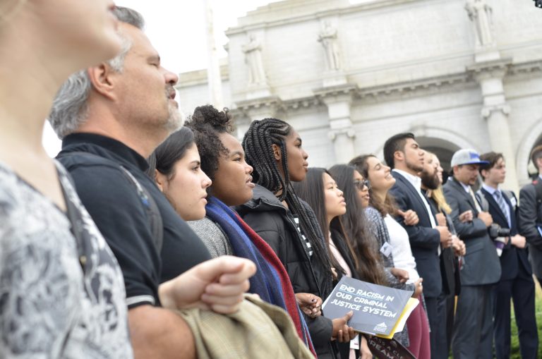 Diverse congregation members attend rally to end racism