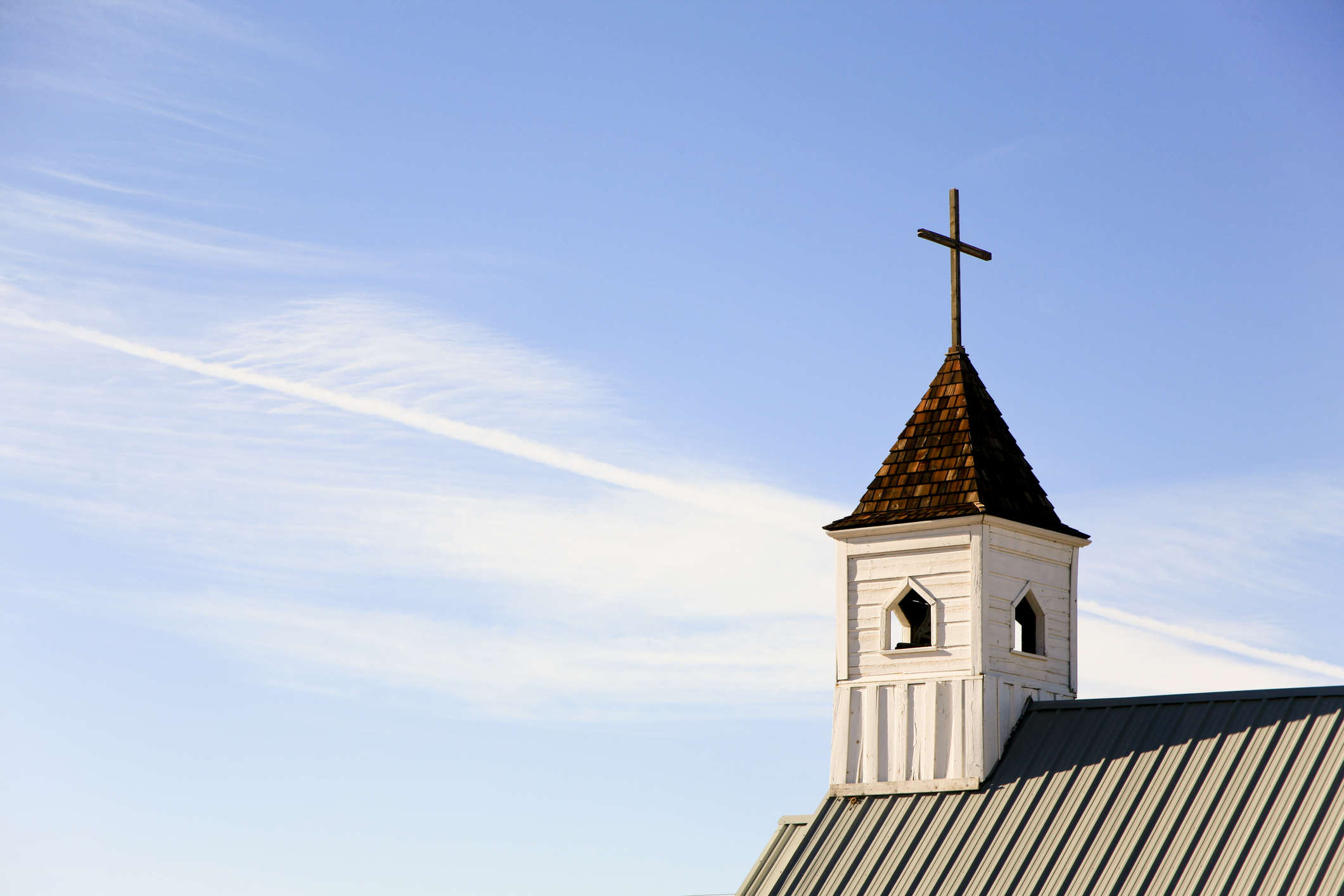 A tower on a white church, Elvis Chapel, at the Superstition Mountain Museum, Apache Junction, Arizona. Lots of blue sky for copy slace.